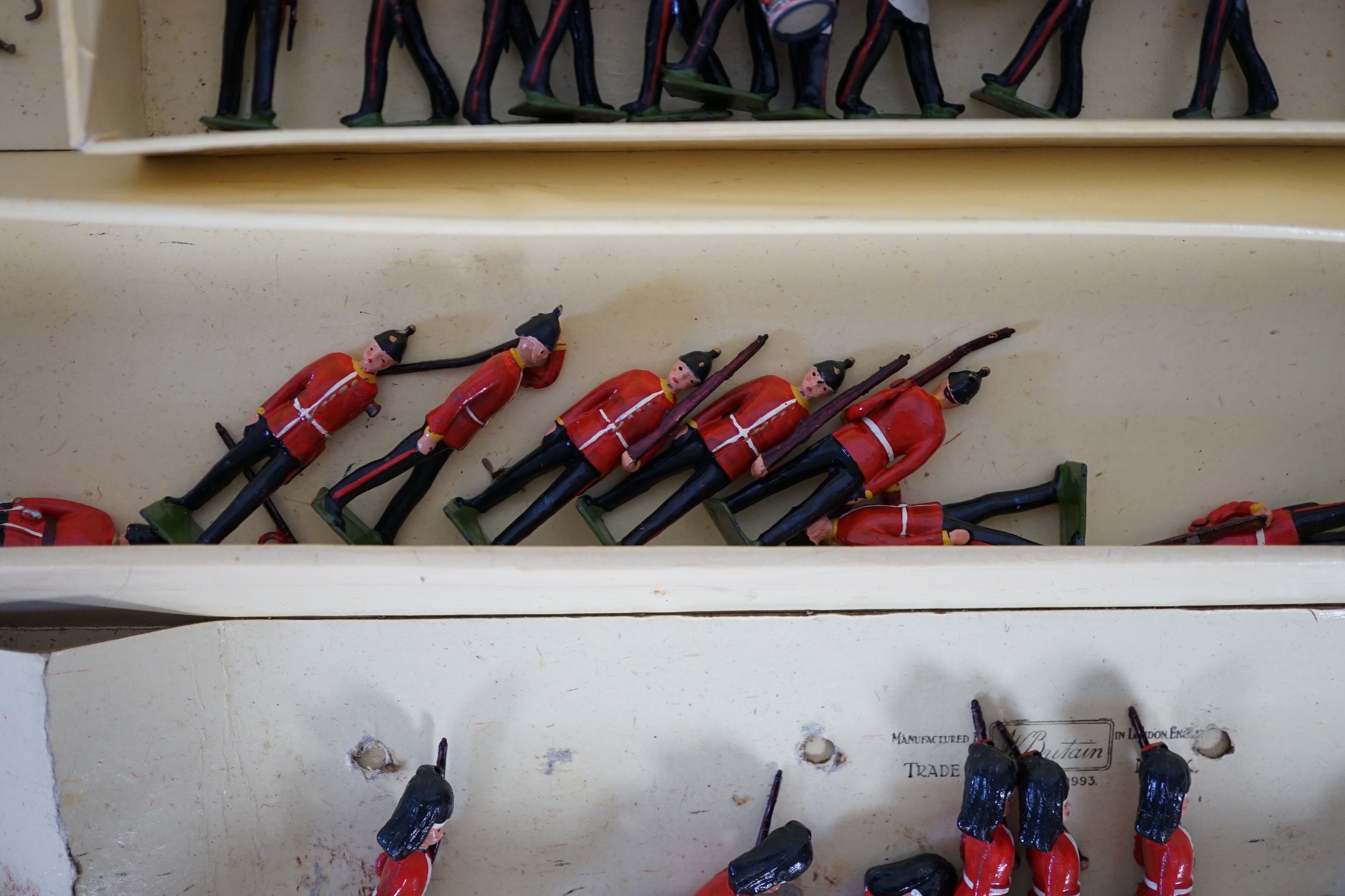 A Britains ‘Regiments Of All Nations’ series box of lead soldiers, including twelve Scottish Highlander infantrymen, eleven marching bandsmen